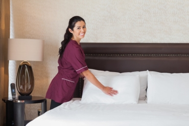Happy hotel maid - Work in hotel room